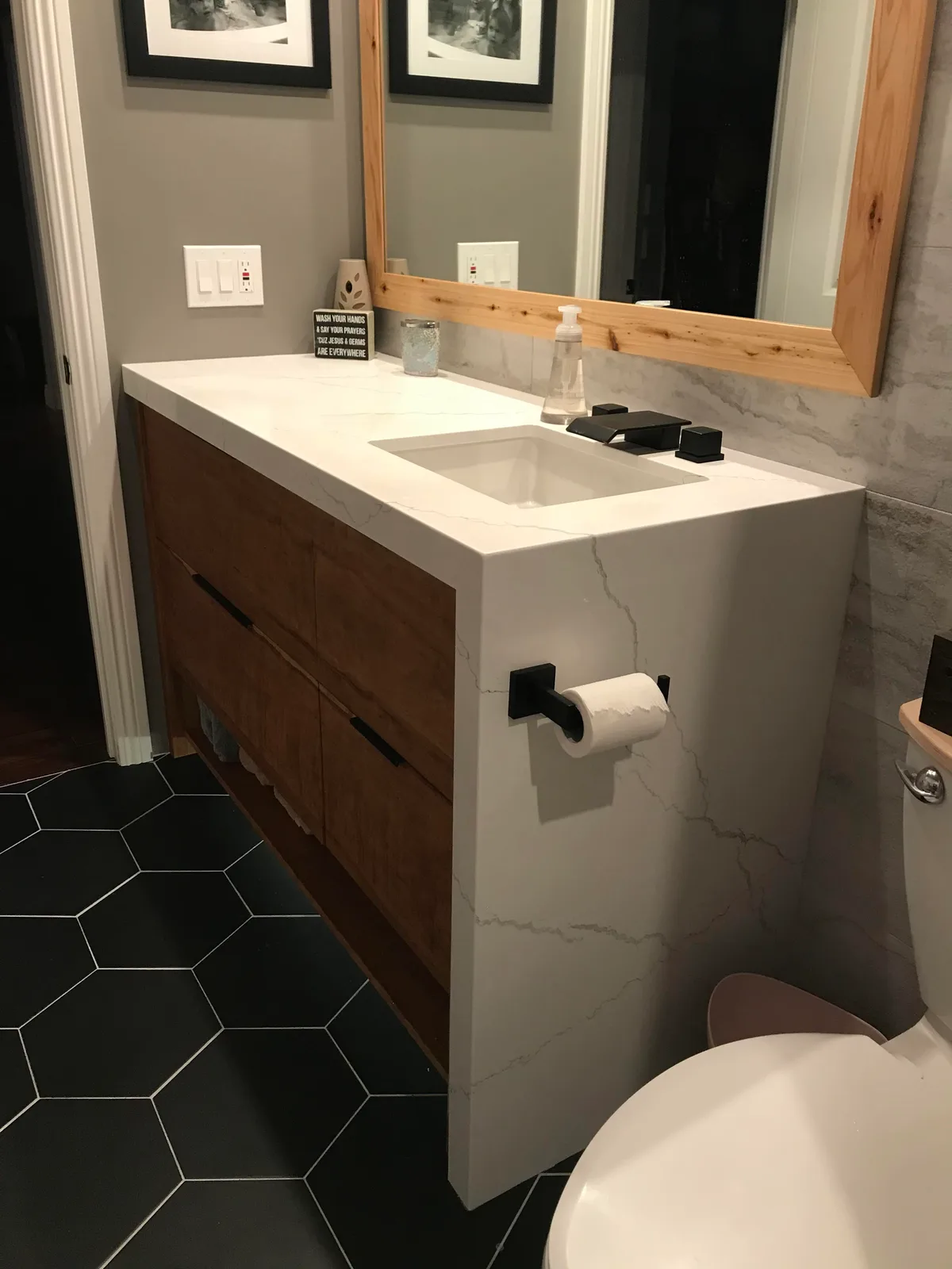 Bathroom remodel with vertical tile feature wall and brass fixtures