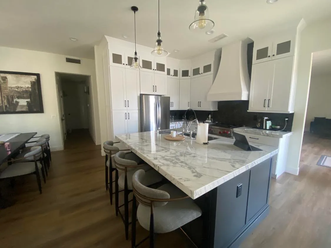 Bright kitchen with light cabinets and stone countertops