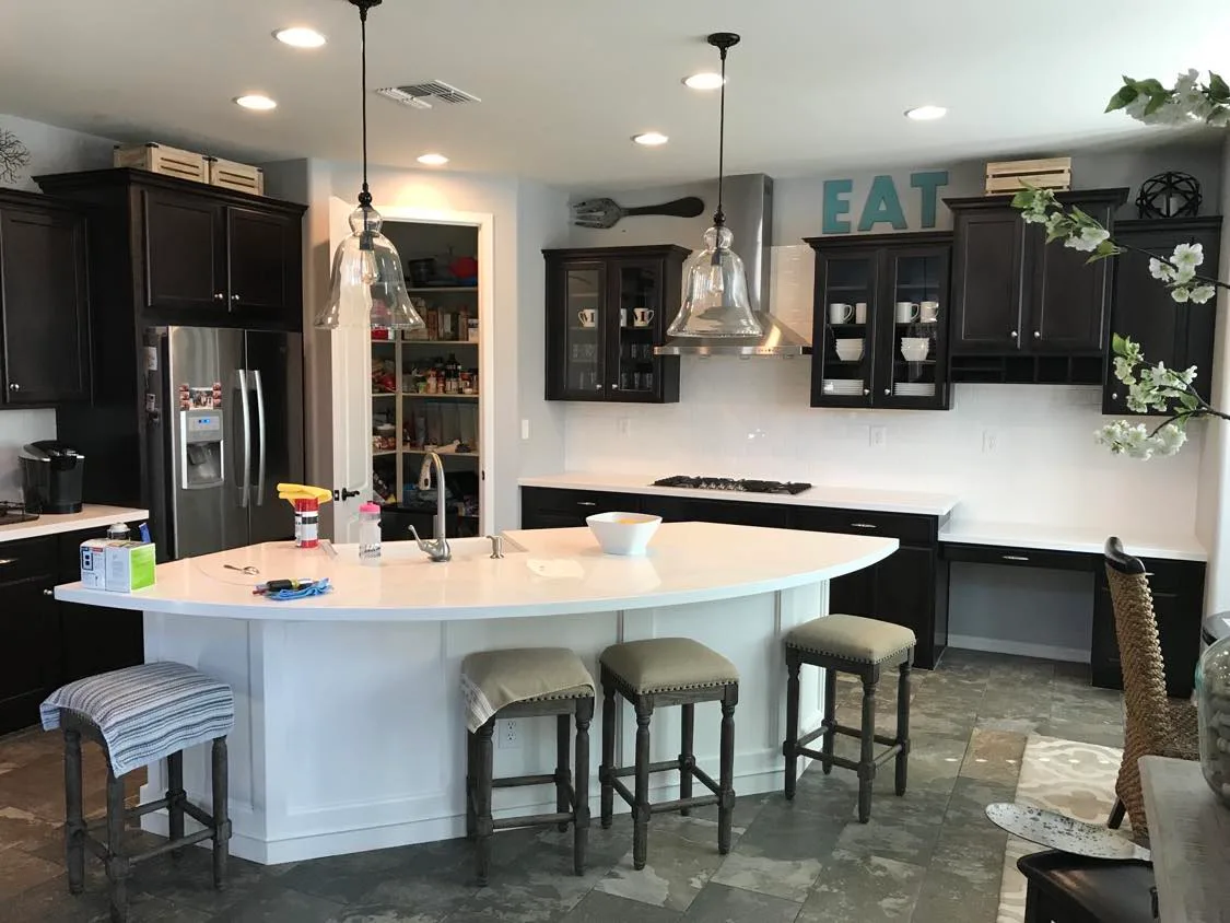 Kitchen island with quartz waterfall and custom storage